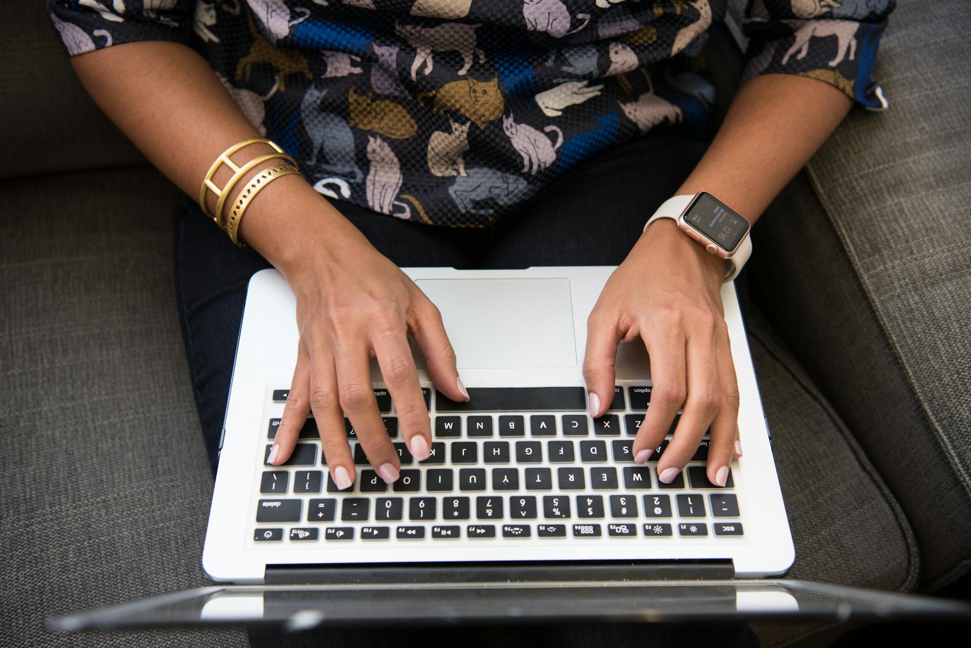 Hands typing on a laptop, illustrating the power of narrative change in shaping policy and social impact.